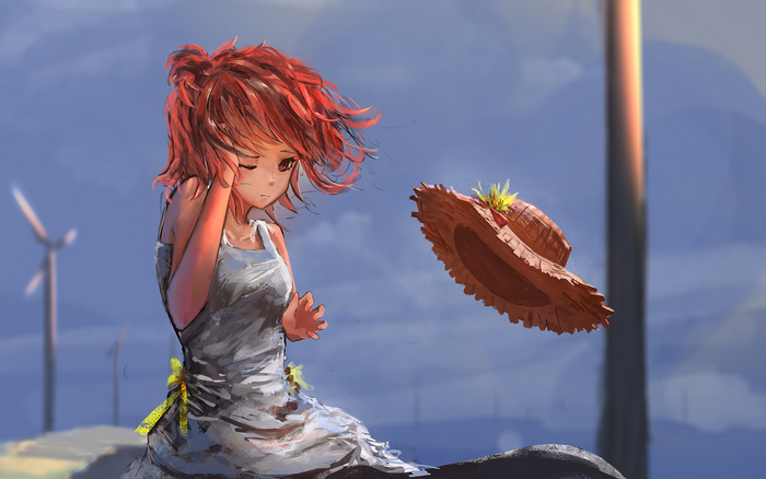Girl with red hair and a straw hat in the wind