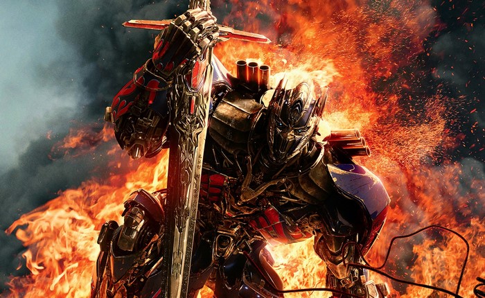 Optimus Prime from Transformers holding a sword in fire