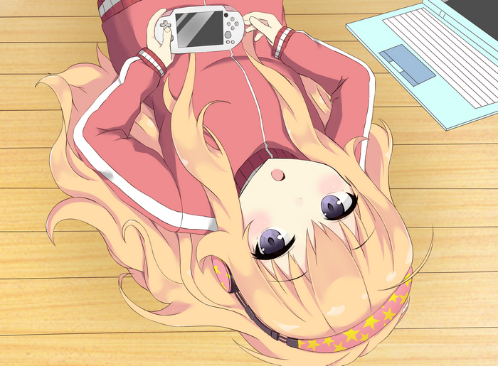 Girl playing PSP next to laptop