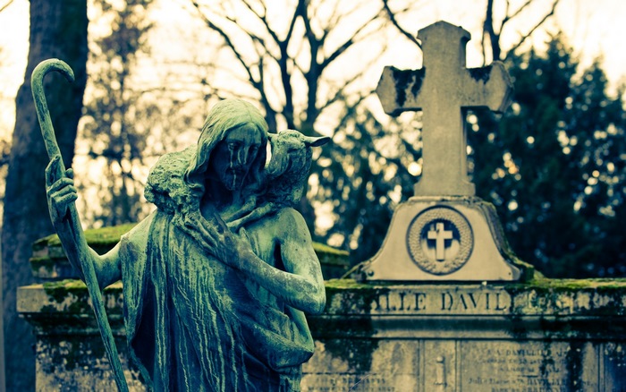 Jesus statue with lamb and cross