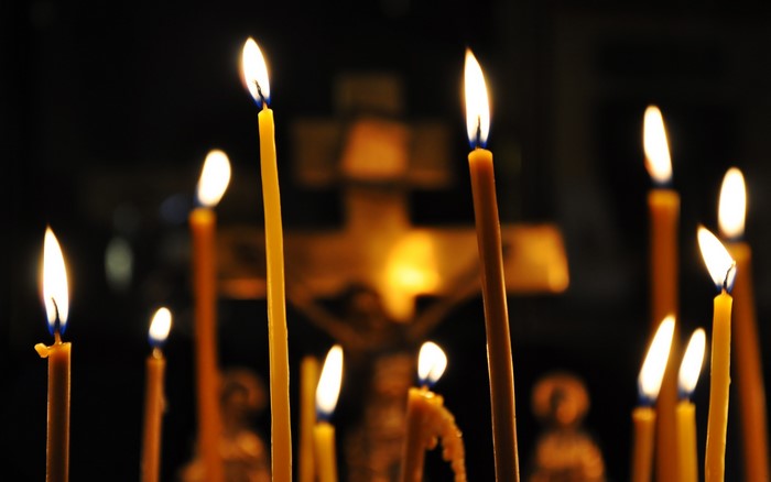 Candles in front of a crucifix