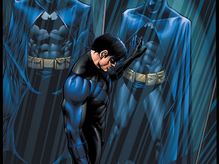 Nightwing looking at his reflection in Batman costume