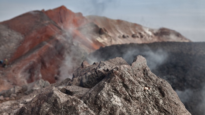 Volcanic landscape with smoke and rocks