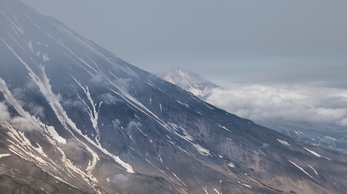 Volcanic mountains with snow and clouds