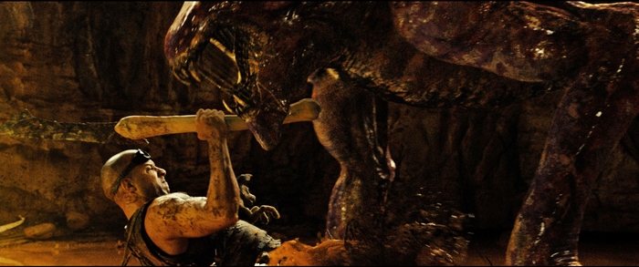 Riddick fighting a creature
