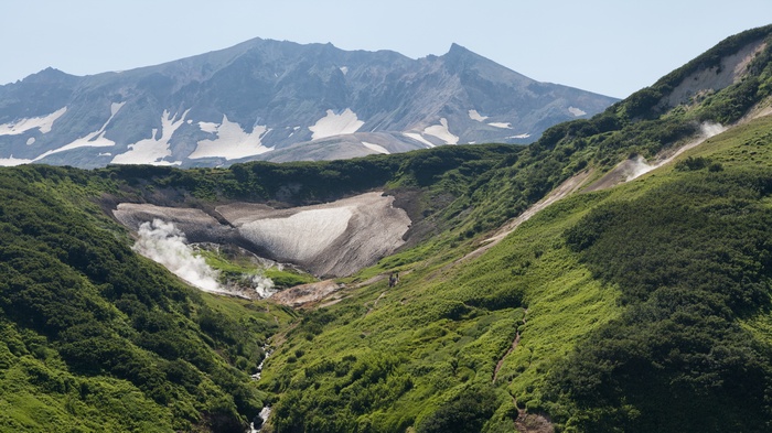 Valley with steaming vents and snow patches