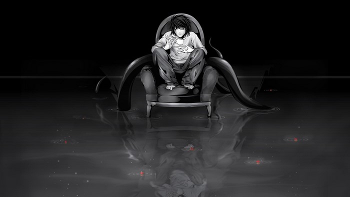 L from Death Note sitting in a chair