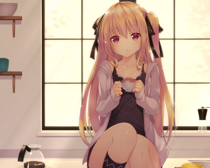Girl with blonde hair drinking tea
