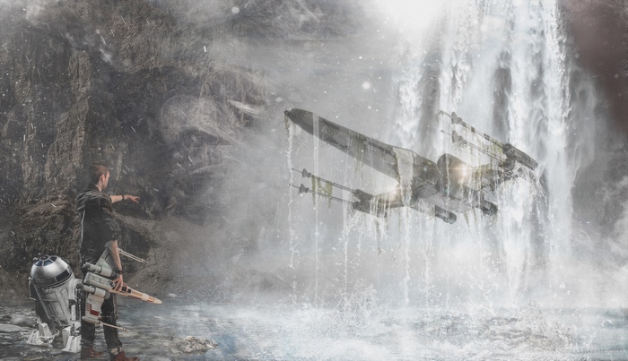Man and R2-D2 with X-wing near waterfall