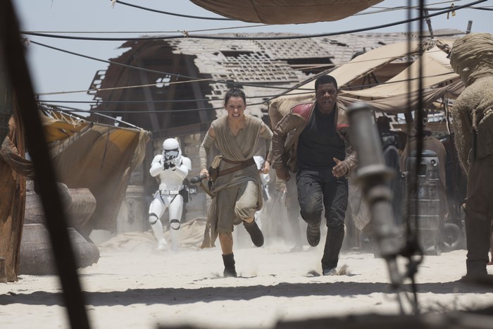 Rey and Finn running from Stormtroopers in Star Wars