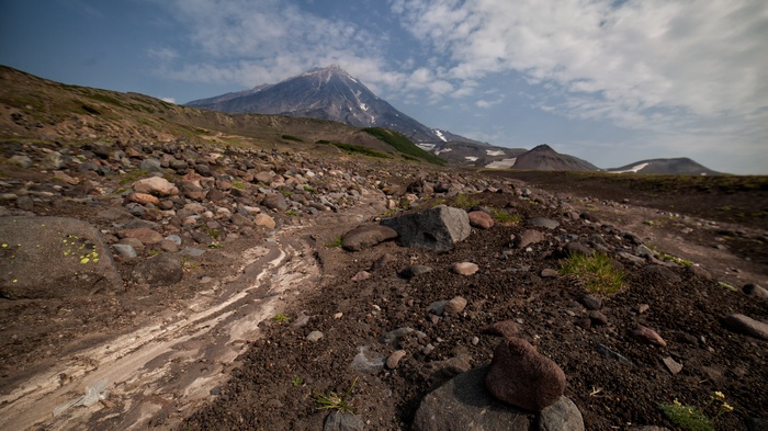 Volcano landscape with rocky terrain and clouds