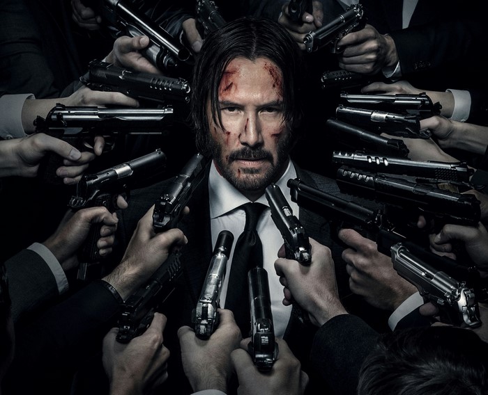 John Wick surrounded by guns
