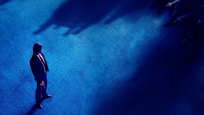 John Wick standing on blue carpet