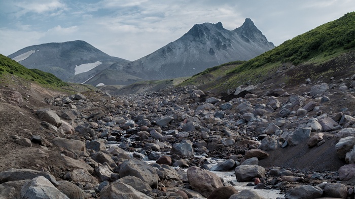Rocky valley with mountains and snow patches