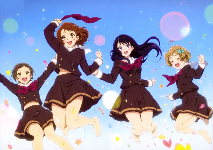 Four girls in school uniforms jumping