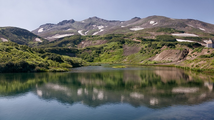 Lake and mountains with snow patches