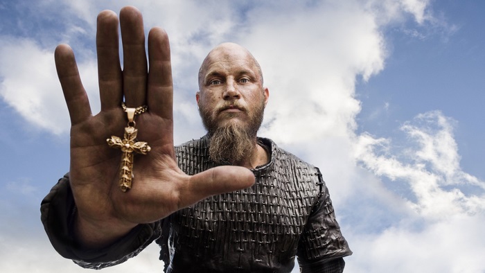 Ragnar Lothbrok holding a golden cross
