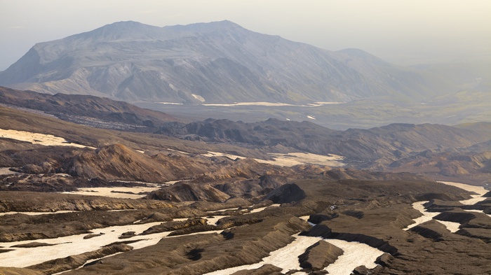 Volcanic landscape with mountains and snow patches
