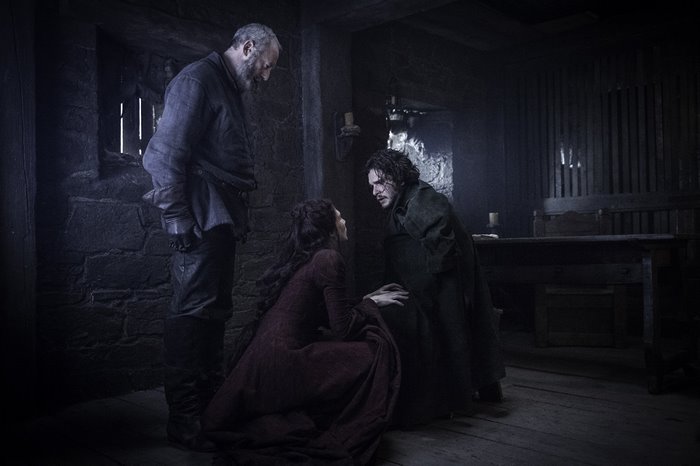 Davos Seaworth, Jon Snow, and Melisandre in a dark room