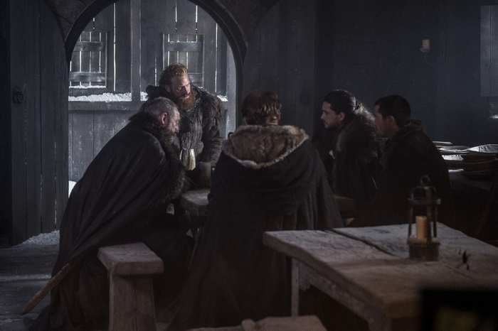 Davos Seaworth and men in a dimly lit room