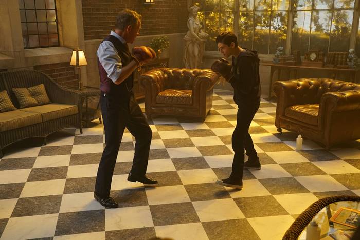 Bruce Wayne boxing in a room
