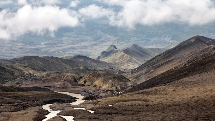 Volcanic landscape with mountains and clouds