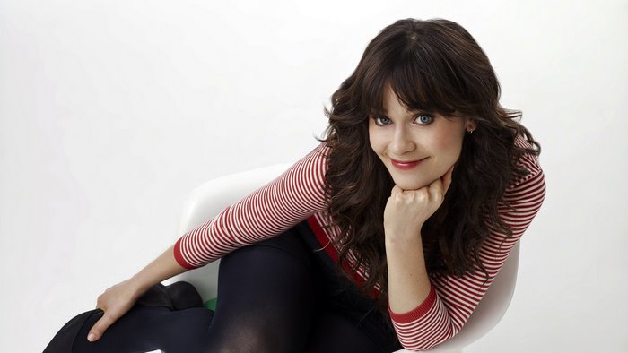 Zooey Deschanel sitting on a chair
