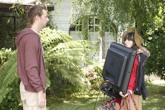 Jessica Day carrying a television