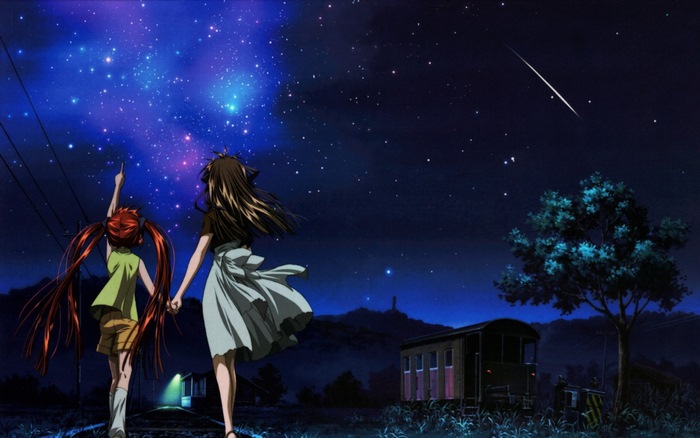 Two girls looking at a starry night sky