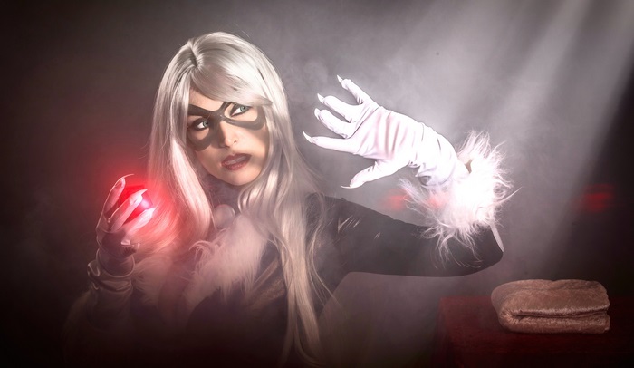 Black Cat holding a red orb
