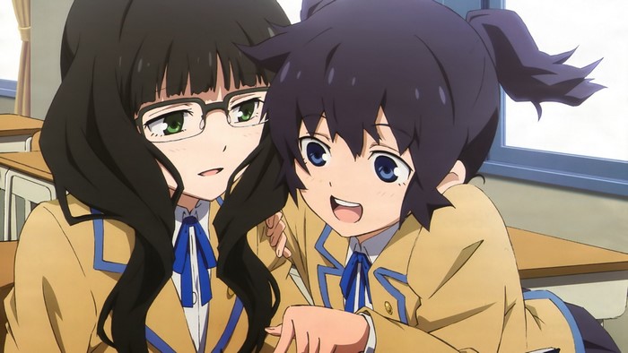 Two girls in school uniforms in a classroom
