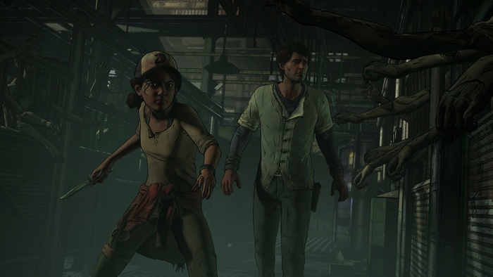 Clementine and man in a dark hallway with zombie arms