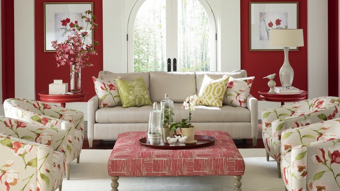 Living room with floral chairs and red walls