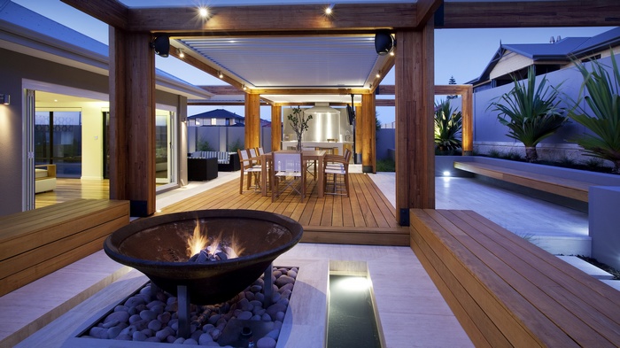 Modern outdoor patio with dining area and fire pit
