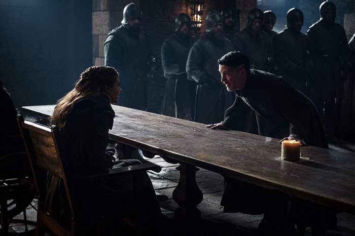 Petyr Baelish and Sansa Stark in a castle hall