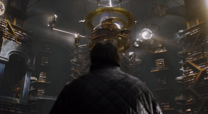 Samwell Tarly in a grand library with an orrery