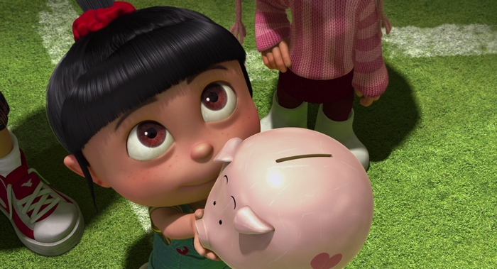 Agnes from Despicable Me holding a piggy bank