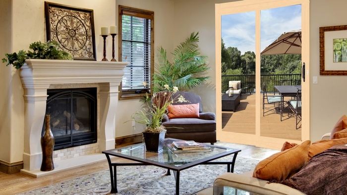 Living room with fireplace and sliding glass doors to a deck