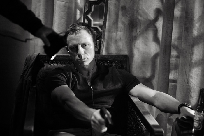 Daniel Craig as James Bond holding a gun