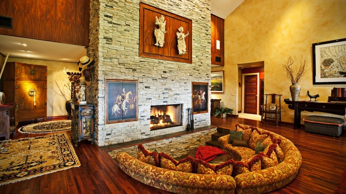 Living room with stone fireplace and circular sofa