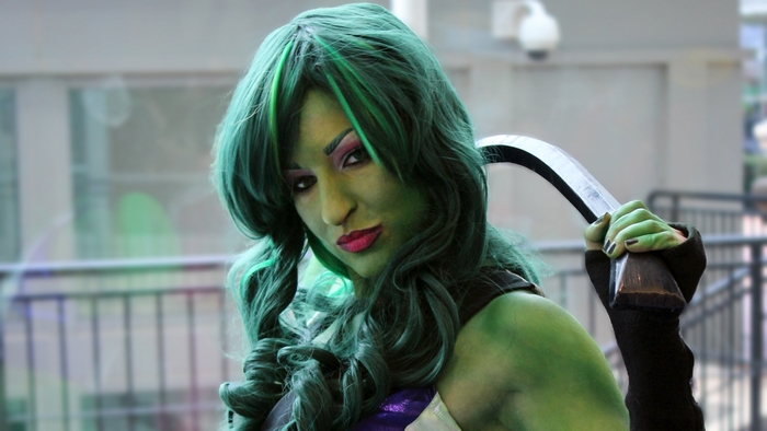 She-Hulk Cosplayer Holding a Weapon