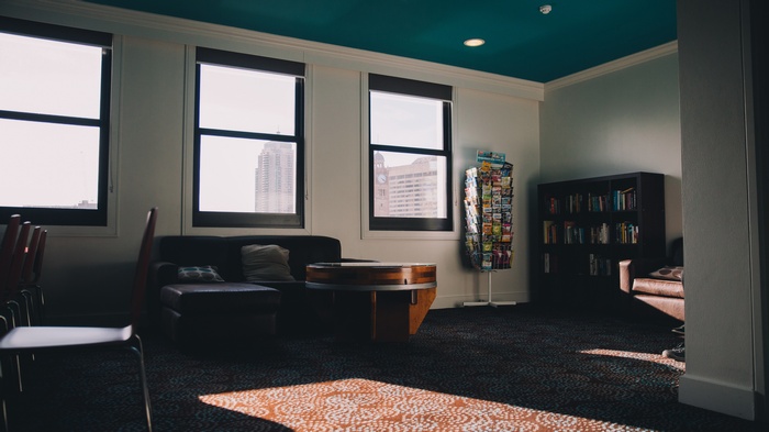 Office lounge with seating and bookshelves
