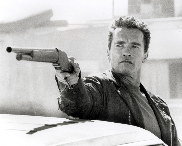 Arnold Schwarzenegger as The Terminator holding a shotgun