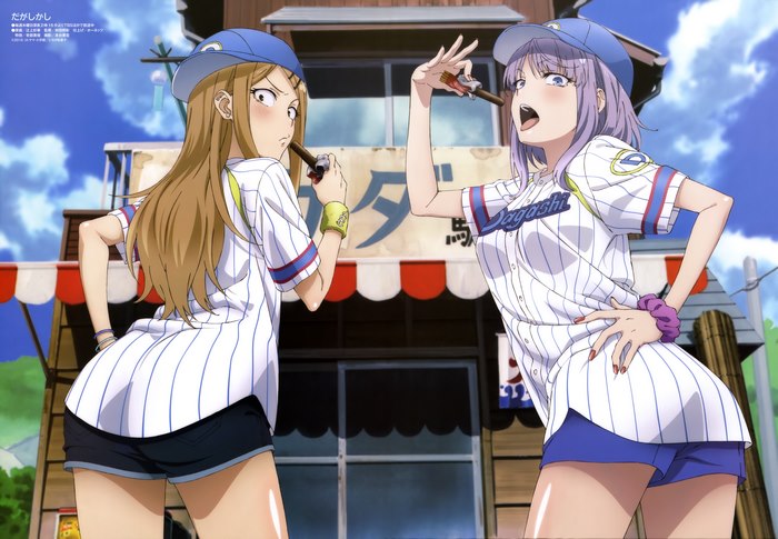 Two girls in baseball uniforms eating snacks