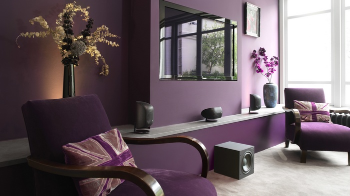 Purple living room with chairs and speakers