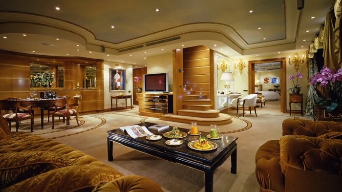 Luxurious hotel suite with dining area and bedroom