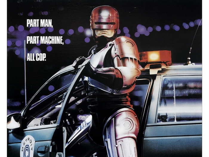 RoboCop leaning on a Detroit police car