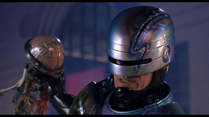 RoboCop holding a brain in a helmet