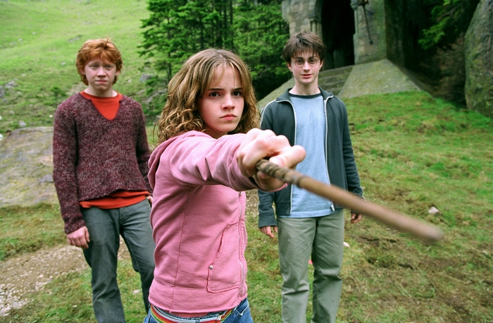 Hermione Granger, Ron Weasley, and Harry Potter with wands