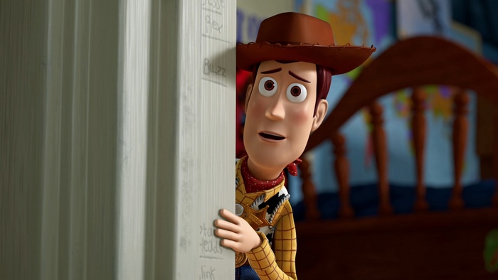 Woody from Toy Story peeking around a corner
